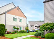 Thumbnail 23 of 24 - Building exteriors and lush landscaping at Devonwood and First Place Apartments, Battle Ground
