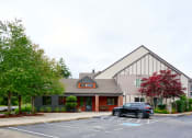 Thumbnail 1 of 24 -  leasing office entrance with parking at Devonwood and First Place Apartments, Battle Ground, WA