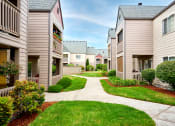 Thumbnail 21 of 24 - Building exteriors and lush landscaping at Devonwood and First Place Apartments, Battle Ground, WA 98604