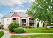 Thumbnail 18 of 24 - Building exteriors and lush landscaping at Devonwood and First Place Apartments, Battle Ground