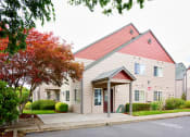 Thumbnail 19 of 24 - Building exteriors and lush landscaping at Devonwood and First Place Apartments, Battle Ground, WA