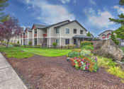 Thumbnail 2 of 63 - Exterior Of Two-Story Units With Small Front Lawns And Bushes at BELLA SONOMA, Fife, 98424