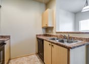 Thumbnail 48 of 63 - Kitchen with Wood Cabinets, Grey Walls, and Black Appliances at BELLA SONOMA, Fife, 98424