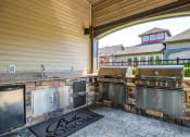 Thumbnail 27 of 63 - BBQ Area with Two Grills, Sink, Mini-Fridge, and Countertop at BELLA SONOMA, Washington, 98424
