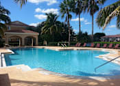Thumbnail 6 of 15 - Pool with lounge chairs at Bernwood Trace Apartments, Fort Myers