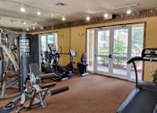 Thumbnail 5 of 15 - Gym with cardio equipment at Bernwood Trace Apartments, Fort Myers, FL