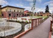 Thumbnail 13 of 16 - A wooden walkway at Bridge Meadows North Portland 55+, Oregon, 97203