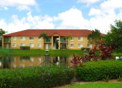 Thumbnail 1 of 14 - Lake with grass and trees at Cross Keys, North Lauderdale, Florida