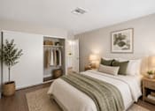 Thumbnail 20 of 22 - Bedroom with open closet and neutral decor at Dash Apartments, Las Vegas, NV