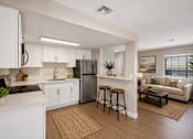Thumbnail 14 of 22 - Open concept kitchen and living room with breakfast bar at Dash Apartments, Las Vegas
