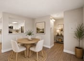 Thumbnail 17 of 22 - Dining area with round table and upholstered chairs at Dash Apartments, Nevada