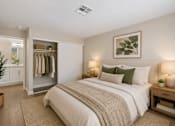 Thumbnail 19 of 22 - Bedroom with walk-in closet and ensuite bathroom at Dash Apartments, Las Vegas, NV
