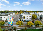 Thumbnail 62 of 81 - an aerial view of an apartment complex with a colorful building in the middle