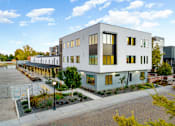 Thumbnail 55 of 81 - a large white building with a courtyard in front of it