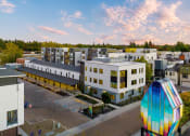 Thumbnail 2 of 81 - Upper Land Park, Sacramento, CA Apartments - Market Club At The Mill - Building Exterior With Street View Of Complex And View Of Sky