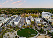 Thumbnail 64 of 81 - an aerial view of a city with buildings and a park
