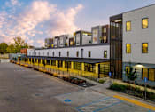 Thumbnail 53 of 81 - a view of a building with many windows and a parking lot