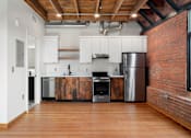 Thumbnail 24 of 81 - a kitchen with white cabinets and a stainless steel refrigerator