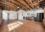Thumbnail 25 of 81 - a large living room with wood floors and white walls