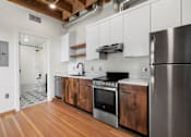Thumbnail 27 of 81 - a kitchen with stainless steel appliances and wooden cabinets