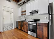 Thumbnail 32 of 81 - a kitchen with white cabinets and stainless steel appliances