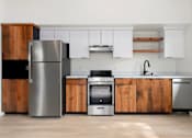 Thumbnail 37 of 81 - a kitchen with stainless steel appliances and wooden cabinets