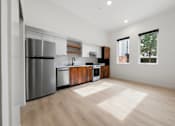 Thumbnail 39 of 81 - an empty kitchen with a stainless steel refrigerator and dishwasher