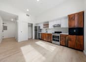 Thumbnail 38 of 81 - a kitchen with wooden cabinets and stainless steel appliances