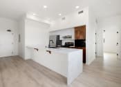 Thumbnail 5 of 81 - a large white kitchen with a white counter top and a white