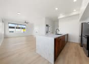 Thumbnail 6 of 81 - a large kitchen with a marble counter top and wooden cabinets