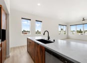 Thumbnail 7 of 81 - a large kitchen with a sink and a counter top