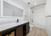 Thumbnail 12 of 81 - a bathroom with a large mirror and a sink and a toilet