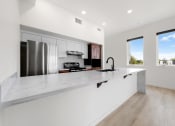 Thumbnail 8 of 81 - a large white kitchen with a large island and stainless steel appliances