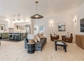 Thumbnail 3 of 6 - A living room with a couch, chairs, and a coffee table at Falls Creek Apartments in ID,