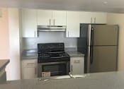 Thumbnail 8 of 11 - kitchen cabinets and stainless steel appliances at The Edge at Town Center Apartments, Jacksonville