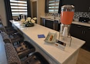 Thumbnail 4 of 11 - lounge area with kitchen at The Edge at Town Center Apartments, Jacksonville, FL, 32224