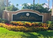 Thumbnail 1 of 19 - Property monument sign in grass at Golden Lakes, Miami, FL