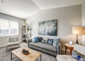 Thumbnail 8 of 63 - Living Room with Wall-to-wall Carpet, Large Window, Couch, Chairs, and Coffee Table at BELLA SONOMA, Fife, WA