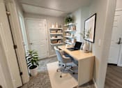 Thumbnail 9 of 10 - A room with a desk, chair, and bookshelf at Cottages at Laguna, CA