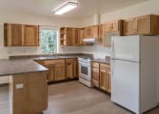 Thumbnail 3 of 8 - Kitchen with appliances and window at TRILLIUM LANDING, JUNEAU, AK 99801