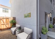 Thumbnail 5 of 41 - a patio with two chairs and a table at THE ANGELINO, Sacramento, CA 95819