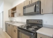 Thumbnail 24 of 34 - Modern Kitchen with Wood-Style Cabinets at FARM BY VINTAGE, MILL CREEK, WA 98012