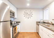 Thumbnail 11 of 19 - Kitchen with stainless steel appliances at THE EDGE Apartments, California