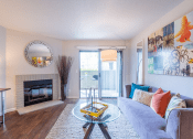 Thumbnail 14 of 19 - Living room with fireplace and patio door at THE EDGE Apartments, DAVIS