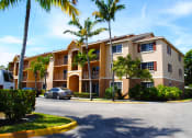 Thumbnail 1 of 13 - Exterior of building with trees at Hibiscus Pointe, Miami, 33147