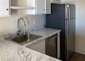 Thumbnail 11 of 19 - A kitchen with a sink and a dishwasher.at Via Casitas, Greenbrae, CA