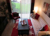 Thumbnail 6 of 11 - Monterey Pointe Apartments apartment home living area with balcony at Monterey Pointe, Homestead, FL
