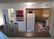 Thumbnail 5 of 11 - kitchen with white appliances and blonde colored cabinetry at Monterey Pointe, Homestead, Florida
