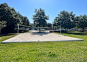 Thumbnail 12 of 21 - a volleyball court sits in the middle of a grassy field at SUMMERBREEZE & SUMMERSET, ST. AUGUSTINE