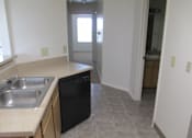 Thumbnail 4 of 28 - A kitchen with a sink and dishwasher.